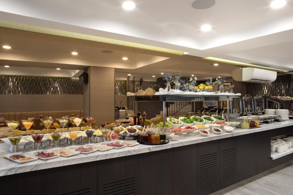 A buffet setup with various food items and beverages.