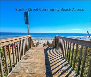 A wooden boardwalk leading to a beach with a 'BONITO' sign. - 🏖️Anchored Inn - updated 4BR/3BA Oceanside home w/Private Pool 🏖️ (Corolla)