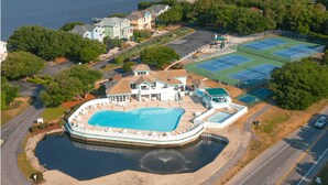 An aerial view of Monteray Shores Community with a large swimming pool, tennis courts, and residential buildings. - 🏖️Anchored Inn - updated 4BR/3BA Oceanside home w/Private Pool 🏖️ (Corolla)