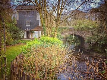 View of the cottage and bridge from the back garden.
