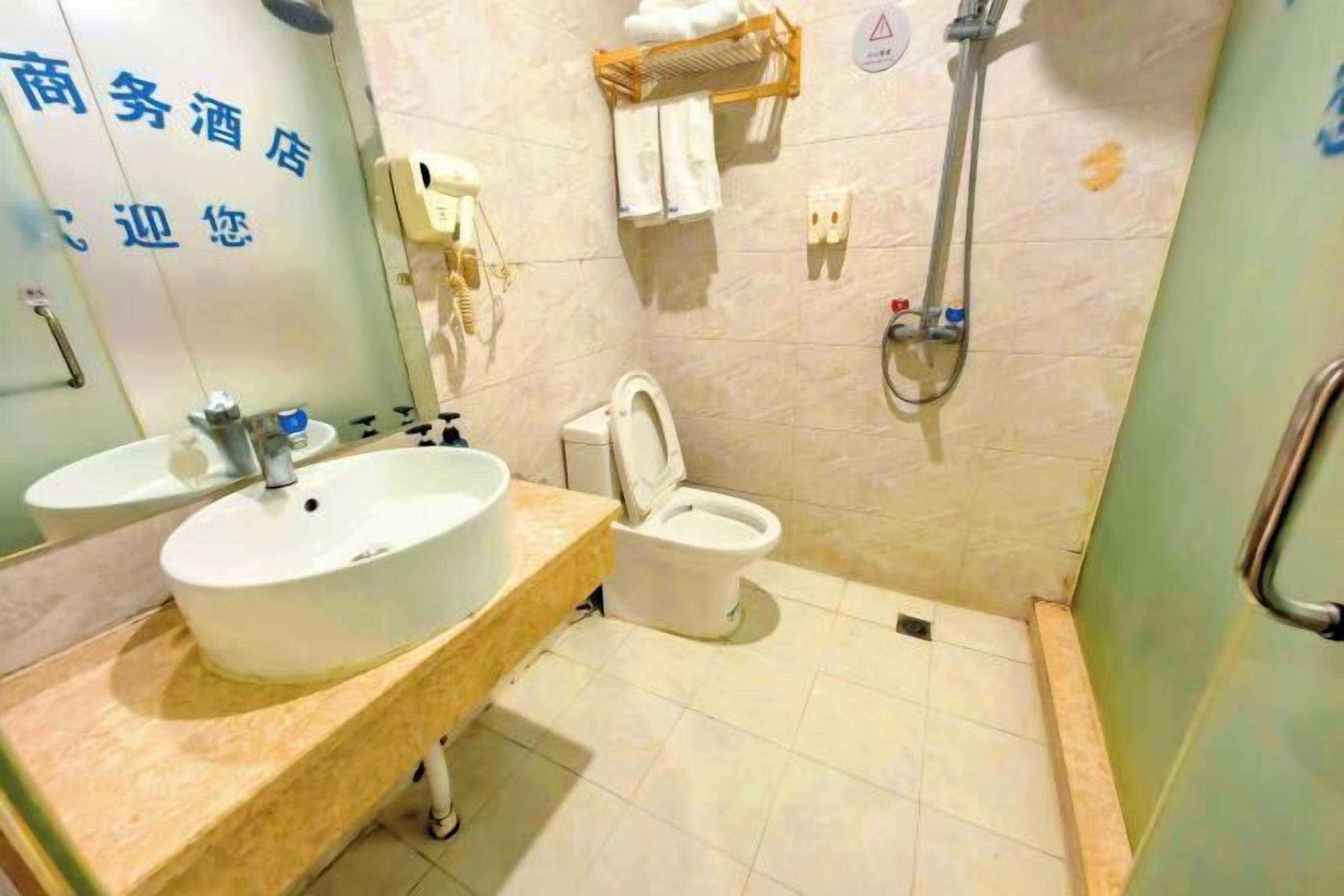 A bathroom with a sink, toilet, and shower.