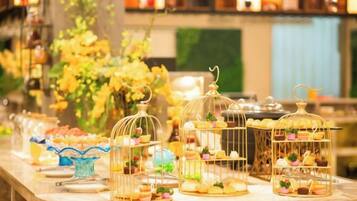A buffet table with various food items displayed in glass containers and on plates.