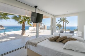 A bedroom with a bed, a TV, and a view of the ocean. - Luxury Villa Lizo with Fabulous View, Pool, Terrace & Wi-Fi (El Campello)