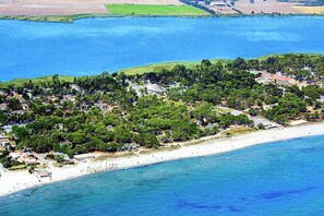 An aerial view of a coastal area with a beach, dense greenery, and scattered buildings. - Very nice villa 12p (6 bedrooms/6 bathrooms) seaside wifi air conditioning terrace garden (Borgo)