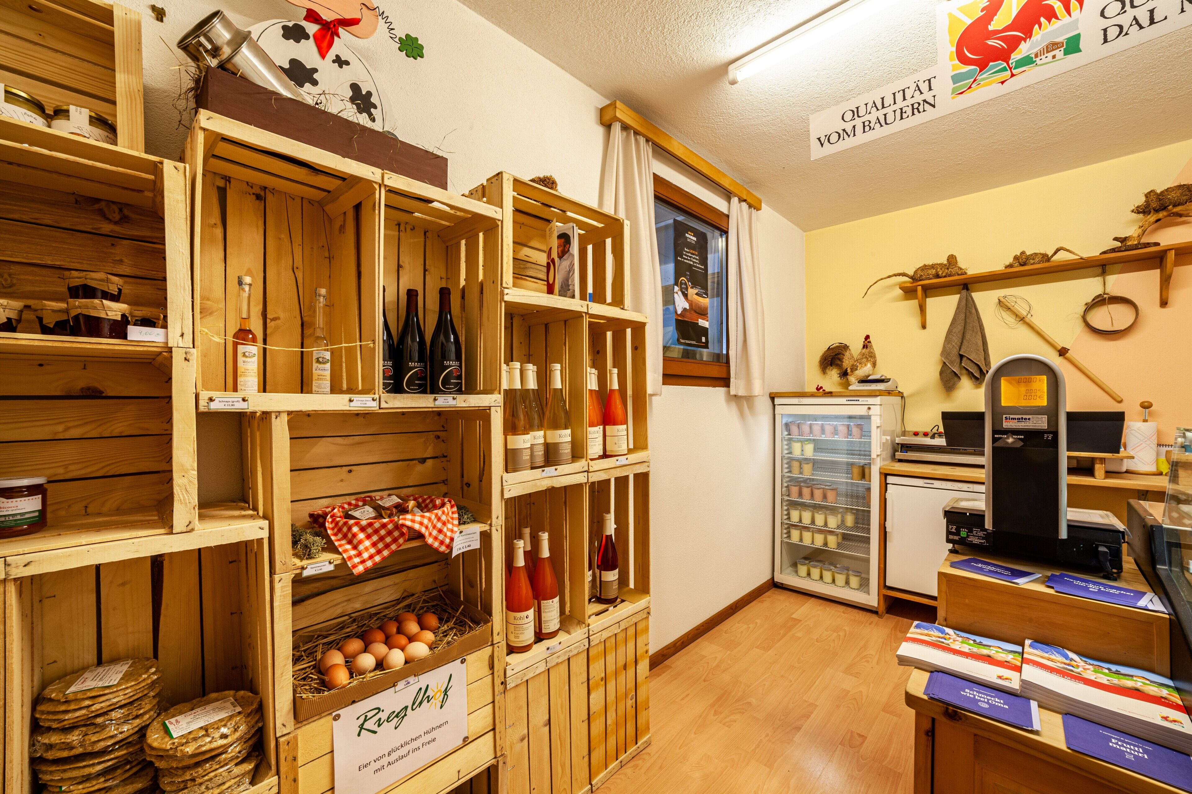 A wooden wine cellar with wooden shelves, wine bottles, and a sign for Riesling.