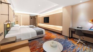Una habitación de hotel moderna con cama, escritorio y zona de estar.