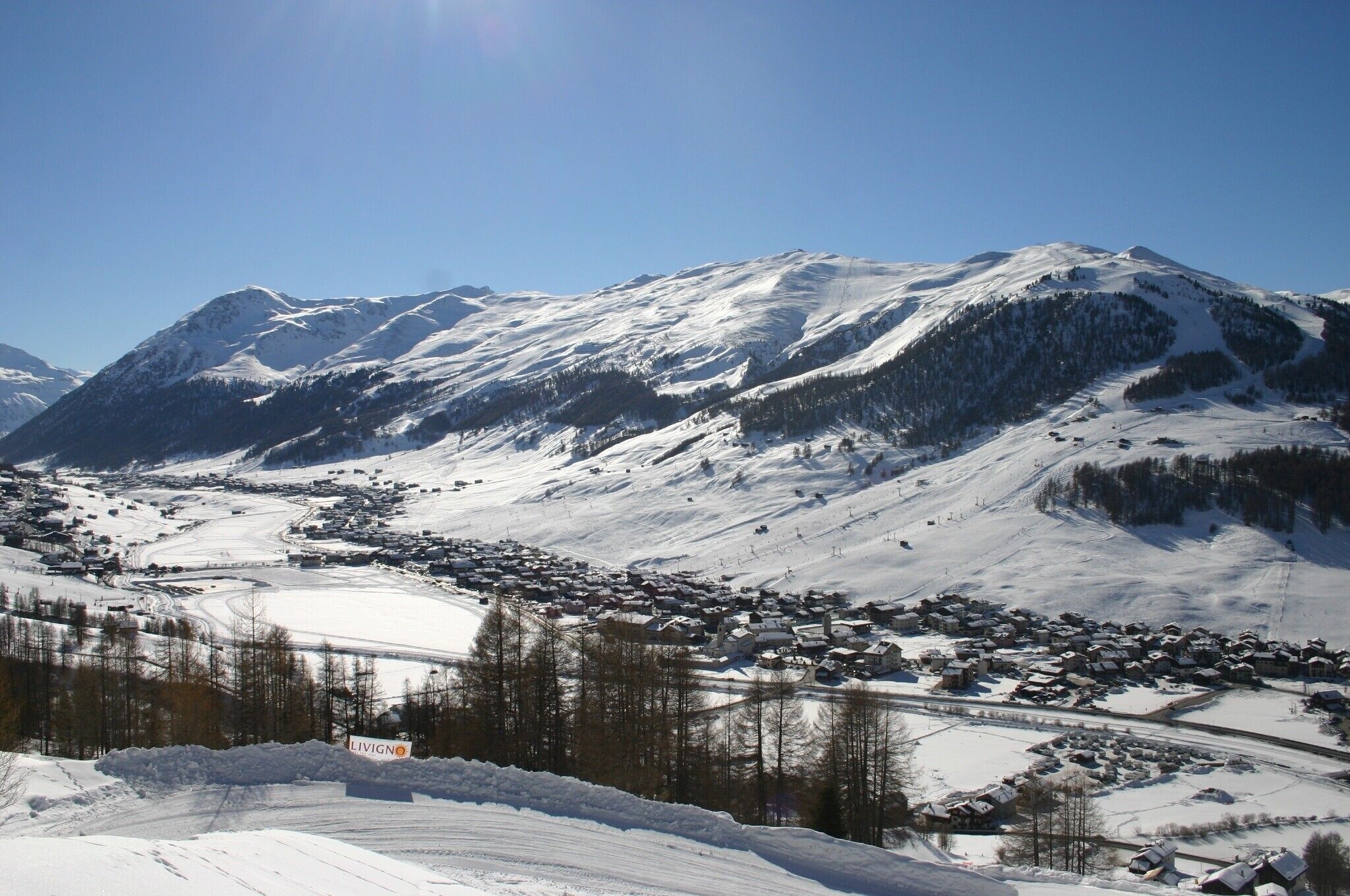 A snow-covered mountain landscape with a town in the valley.