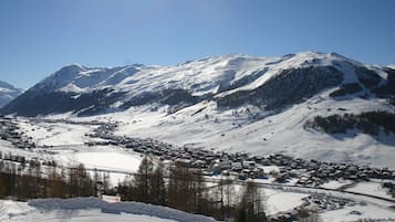 A snow-covered mountain landscape with a town in the valley.