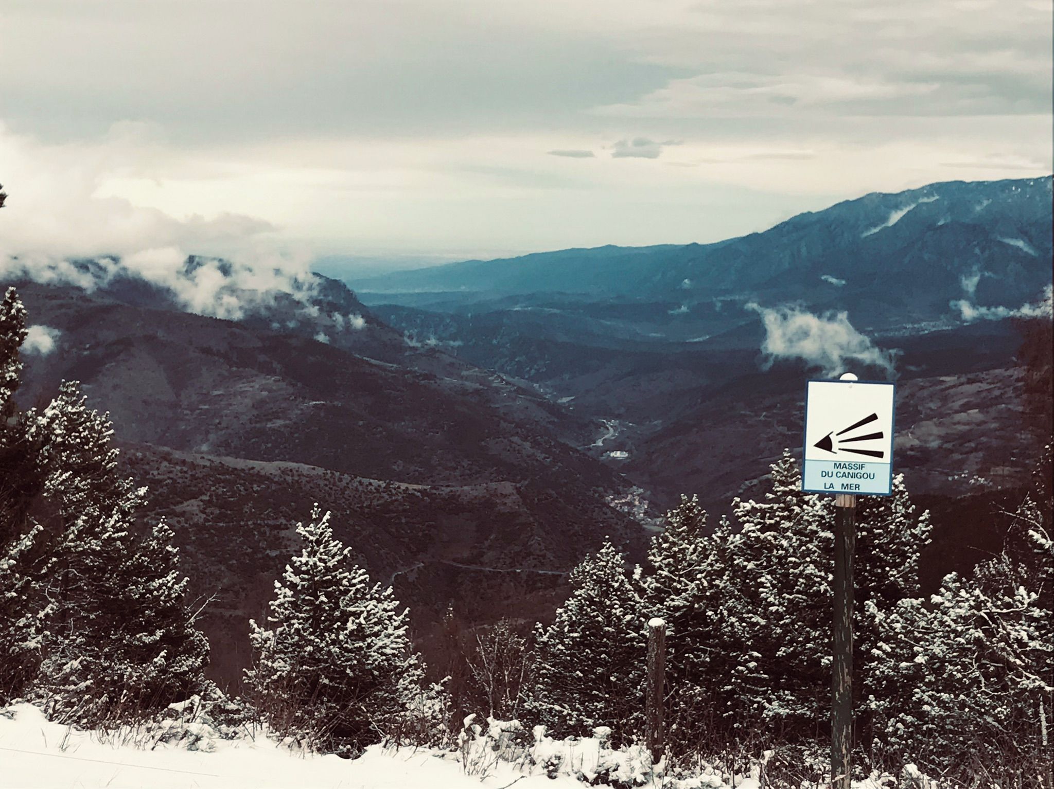 A sign indicating the direction to the Massif du Canigou mountain range.