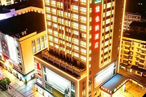 A multi-story building with illuminated windows and signage. - Vienna Hotels（hunan zhuzhou green shop） (Zhuzhou)