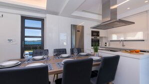 A modern kitchen with a dining area. - Imperium Lux Villa Esperia★100m to sea★Heated Pool★Gym★Sauna & Jacuzzi (Chania)