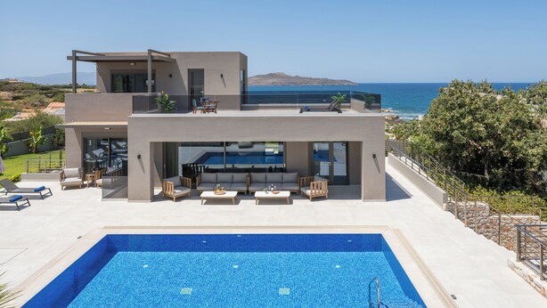 A modern two-story house with a swimming pool, outdoor seating, and a view of the sea. - Imperium Lux Villa Esperia★100m to sea★Heated Pool★Gym★Sauna & Jacuzzi (Chania)