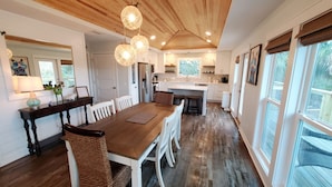 A spacious kitchen with a wooden ceiling, white cabinets, and a large island. - Private Pool! Easy Beach Access! (St. George Island)