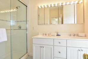 Bathtub, hair dryer, towels, shampoo