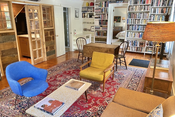 Mid-century furniture, books galore, and a quaint farmhouse kitchenette.