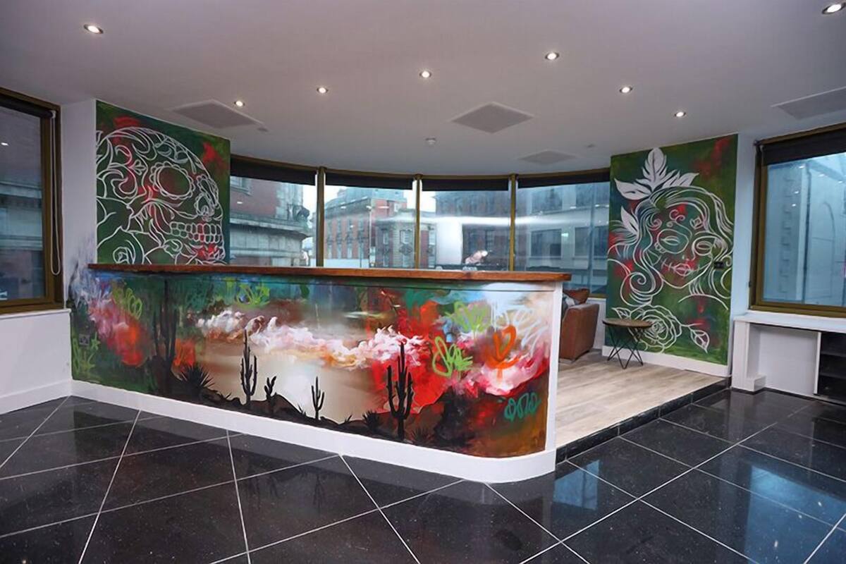 A reception area with a curved counter, large windows, and abstract wall art.