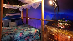 A room with a bed, a canopy, and a rope bridge. - Shipwrecked-VERY COOL couple's ATL area theme suite! (Carroll County)