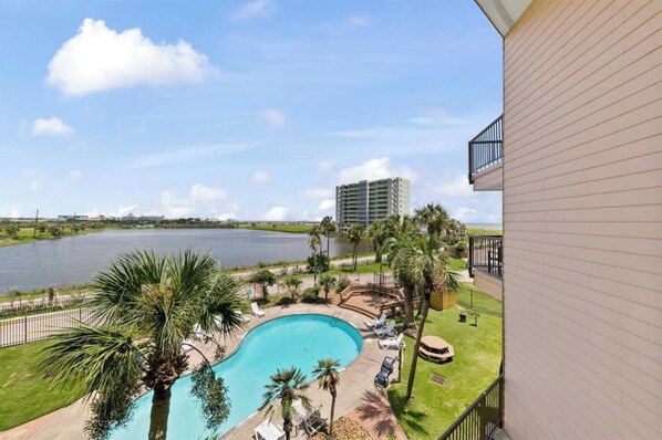 Enjoy breathtaking views of the pool and surrounding water from this property's balcony.