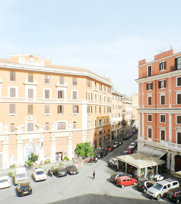 A street view with parked cars and buildings.