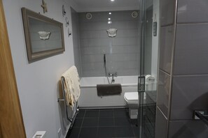 Bathtub, hair dryer, towels, soap