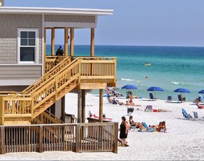 A beach house with a wooden deck and stairs leading to a balcony overlooking the ocean. - ⛱️2 Pools–Beach Shuttle–4 Bikes–5BR Miramar Magic✨ (Miramar Beach)