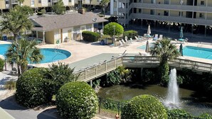A hotel with multiple swimming pools, a bridge, and a fountain. - Your Tybee Island Escape – Oceanfront Condo 20C (Tybee Island)