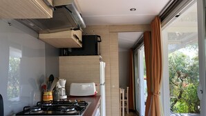 A modern kitchen with a gas stove, a toaster, and a coffee maker.