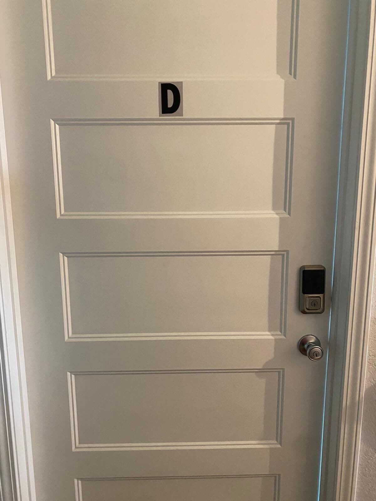 A door with a digital lock and a keypad, marked with the letter 'D'.