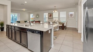 A spacious kitchen with a large island, built-in dishwasher, and stainless steel appliances. - 6 bedroom 5 bathroom with Spa and Games Room Brand New Modern Furnishings (Davenport)