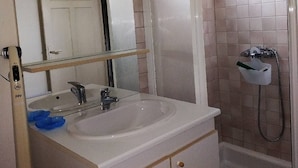 A bathroom with a white sink, a mirror, and a shower area. - Near thermal baths and beach, 2-room apartment for rent in 2* chalet (Grésy-sur-Aix)