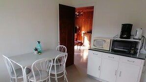 A compact kitchen with white cabinets, a microwave, and a coffee maker. - Near thermal baths and beach, 2-room apartment for rent in 2* chalet (Grésy-sur-Aix)