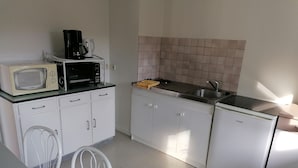 A compact kitchen with white cabinets, a microwave, a toaster, and a sink. - Near thermal baths and beach, 2-room apartment for rent in 2* chalet (Grésy-sur-Aix)