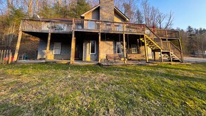 A two-story house with a balcony, a staircase, and a front porch. - Windrock Retreat (Oliver Springs)