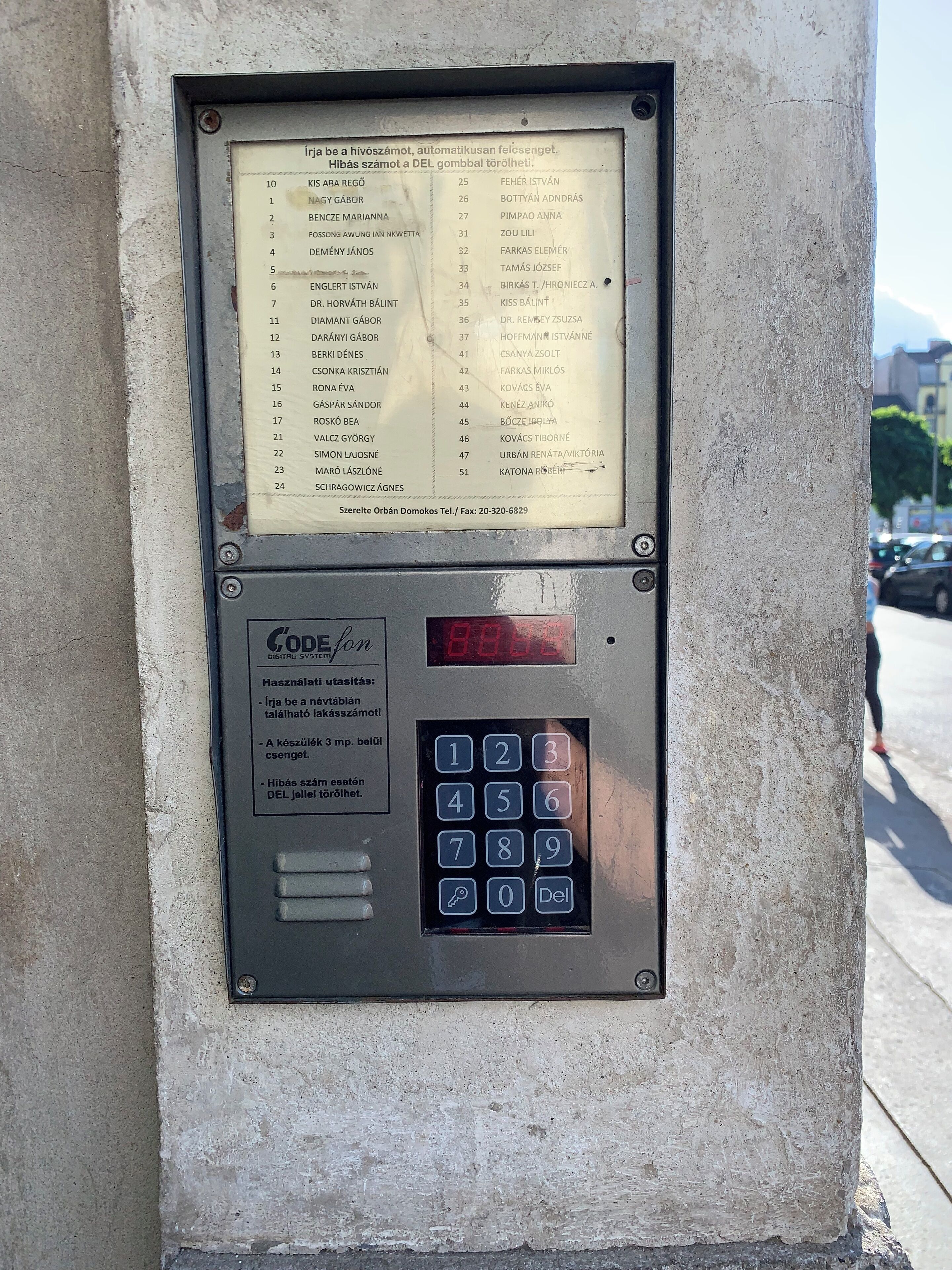 A digital directory with a list of names and numbers, a keypad, and a small screen displaying '8888'.