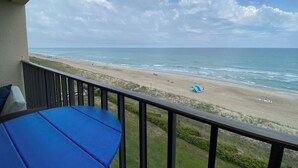 A balcony with a view of a beach and ocean. - Oceanfront condo at Summer Winds Resort in Indian Beach, NC (Indian Beach)