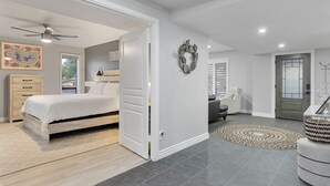 A spacious bedroom with a large bed, a wardrobe, and a ceiling fan. - Scottsdale Relaxation by the Pool! (Scottsdale)
