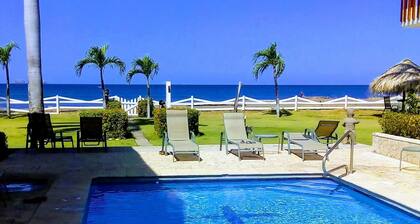 Beachfront one-bedroom, ocean view condo with toes in the sand!