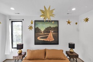 A bedroom with a large bed, two bedside tables with lamps, a window with curtains, and a wall-mounted painting. - Alexander Dr 7 Minutes to Northshore (Chattanooga)