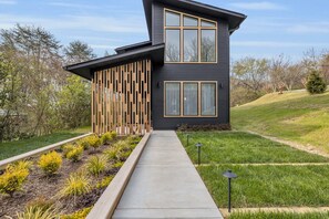 A modern two-story house with a dark exterior, large windows, and a wooden slatted wall. - Alexander Dr 7 Minutes to Northshore (Chattanooga)