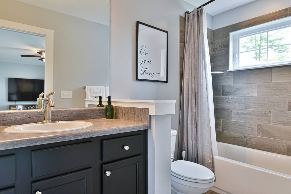 Bathtub, hair dryer, towels, shampoo