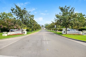 A street view of a residential area named 'SILVERADO' with a clear road, well-maintained lawns, and trees.