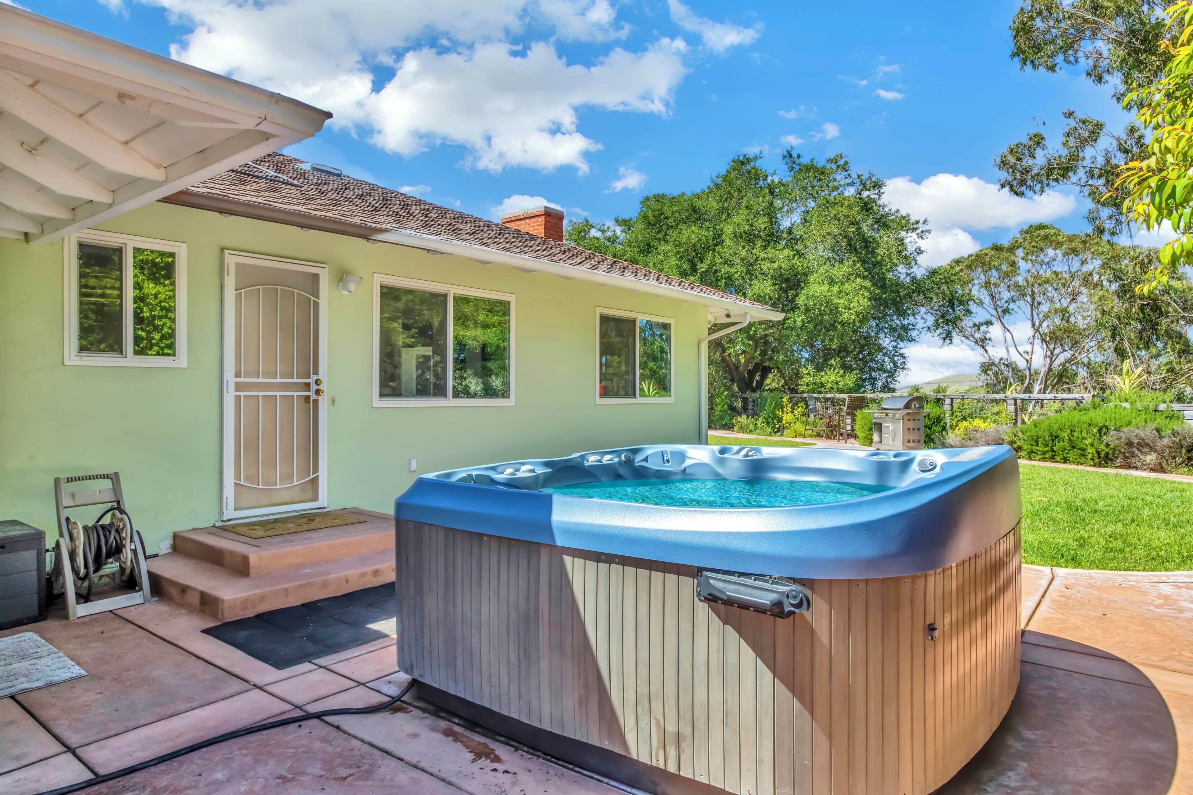 A house with a hot tub in the backyard.
