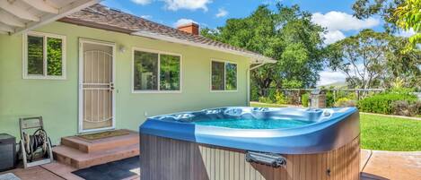 A house with a hot tub in the backyard.
