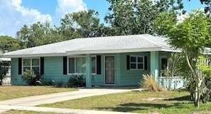 A single-story house with a gabled roof, a front porch, and a small front yard.