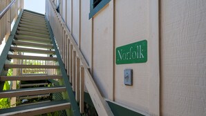 A staircase leading to a building with a 'Norfolk' sign on the wall. - Full 🌊 Views & 🌋Views Watch the🌅 and 🌕 rise (Koloa)