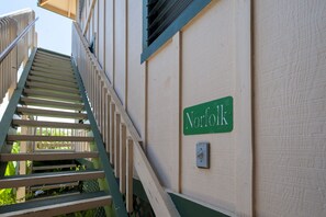 A staircase leading to a building with a 'Norfolk' sign on the wall.