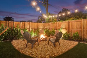 Relax by the fire pit in a cozy outdoor space surrounded by comfortable seating.