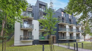 A modern apartment building with balconies, a grassy courtyard, and a fence. - Vacation apartment by the sea, vacation on the island of Usedom, Apartment Matejki 2 (Swinoujscie)