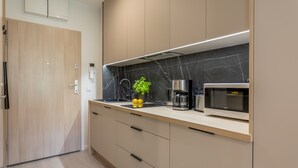 A modern kitchen with a marble backsplash, a built-in microwave, and a coffee maker. - Vacation apartment by the sea, vacation on the island of Usedom, Apartment Matejki 2 (Swinoujscie)