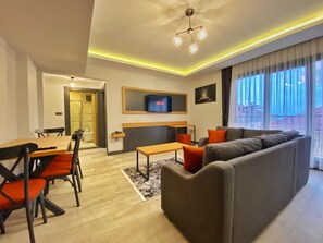 Superior Apartment | Living area | 120-cm Smart TV with satellite channels, TV - My House Suite (Trabzon)